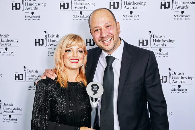 The Room 97 team on the British Hairdressing Awards red carpet, holding a trophy