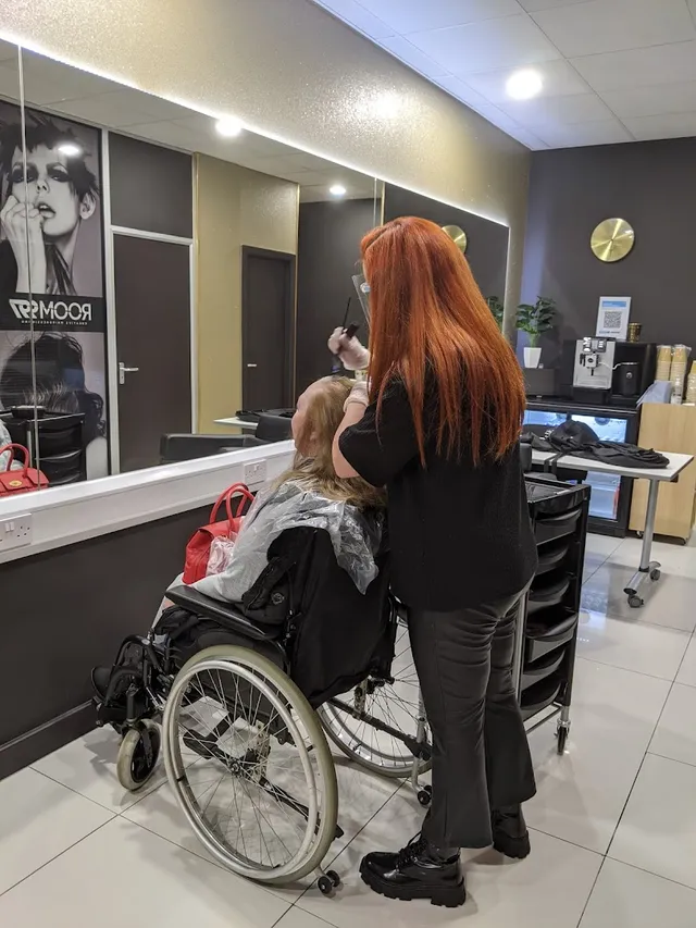 A Room 97 stylist colouring a client in the salon